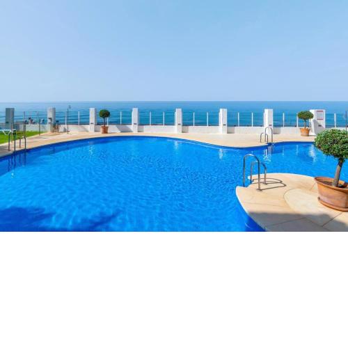 Beachfront 2BR with swimming pool, parking & AC